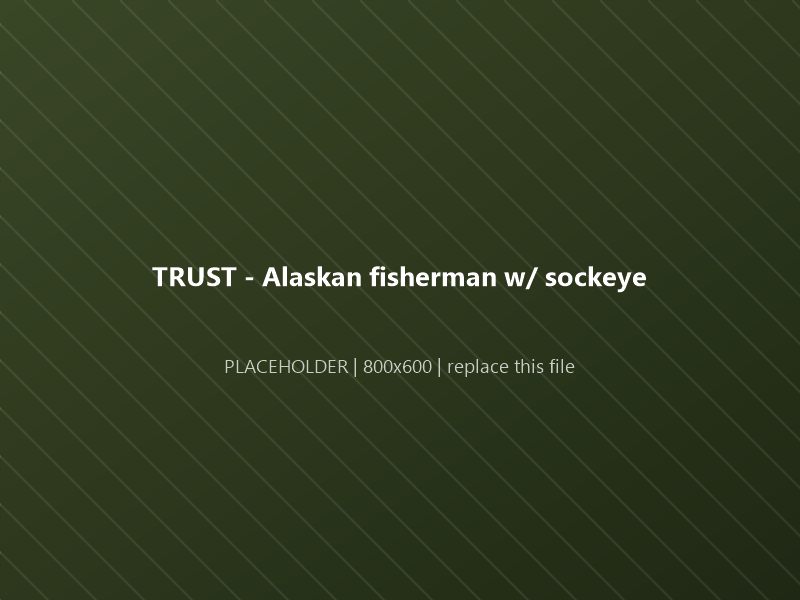 An Alaskan fisherman holding a freshly caught sockeye salmon